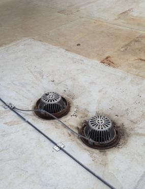 The metal roof drains are bonded to the roof conductor that passes close to them.